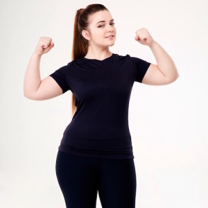 Happy fat woman showing her biceps