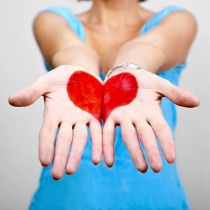 red heart on the palms of a woman