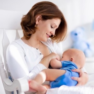 Nice young mother with baby boy at home