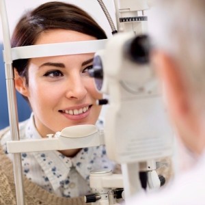 Woman look in ophthalmoscope
