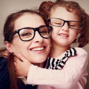 Loving happy mother and smiling daughter hugging. Vintage closeup portrait