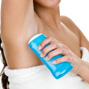Woman applying deodorant