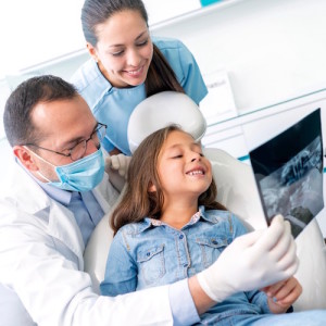 Girl at the dentist looking at an x-ray