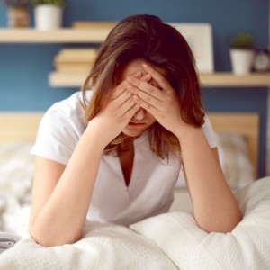 Unhappy girl in a bedroom