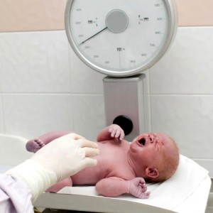 Weighting a newborn.